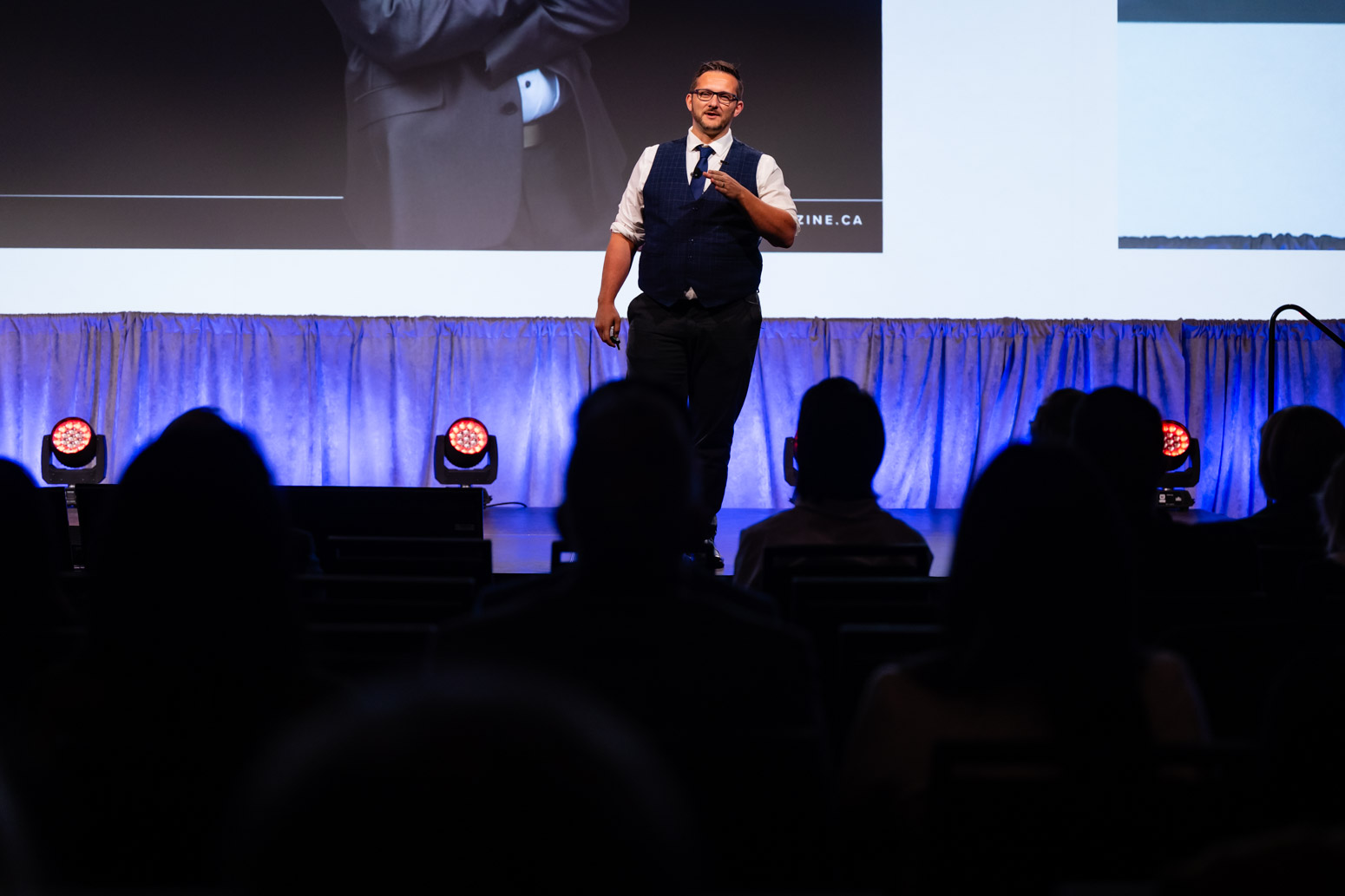 Andrew Fogliato speaking on stage at RE/MAX Activate 2025